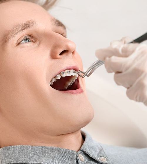 Man with braces visiting his orthodontist