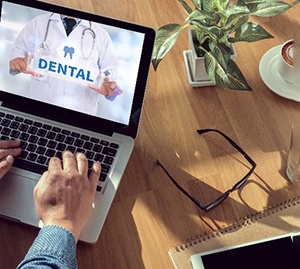 Dental insurance information on computer with desk supplies